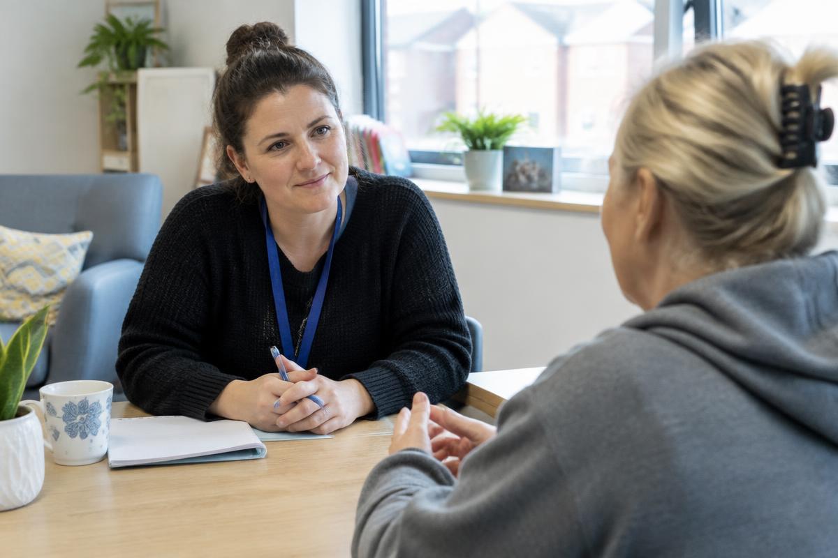 A support worker and resident talking together